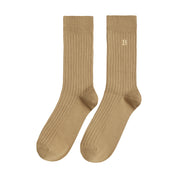 Pair of taupe socks with a logo on a white background